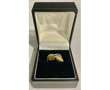 An 18ct gold diamond and sapphire crossover ring, size K/L, 4.9g, boxed 