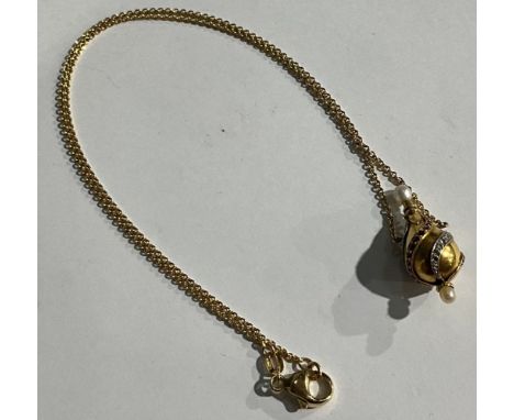 An 18ct gold pendant as a phial, set with bands of graduated diamond, ruby and emerald chips, seed pearl terminals, the integ