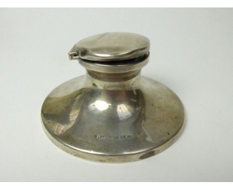 A silver capstan inkwell, maker's mark rubbed, dented, weighted base, Birmingham 1931