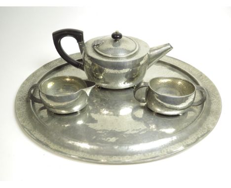 A Tudric Pewter three piece tea set all numbered 01536.  (Dented base to teapot) and a Tudric Pewter made by Liberty &amp; Co