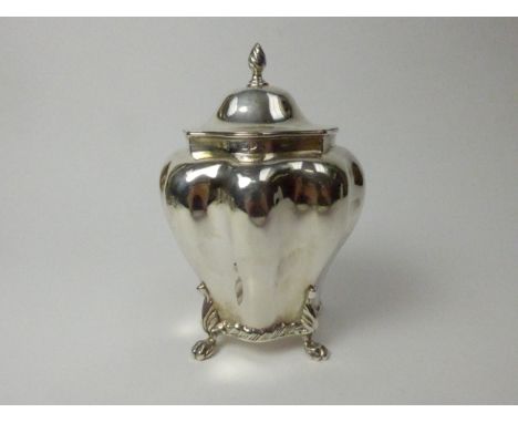 A George Nathan &amp; Ridley Hayes silver tea caddy of melon form with paw feet, 14.5cm diameter, marks rubbed, Chester 1897,