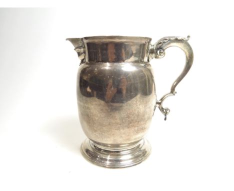 A George III William Grundy milk pitcher with acanthus leaf S-scroll handle with circular foot, London 1770, 14cm, 387g