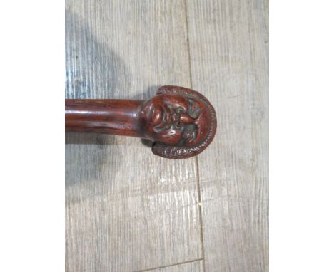 A 19th Century walking stick, the knop carved with the bust of an 18th Century gentleman, 126cm tall