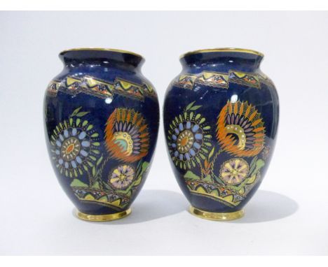 A pair of Carlton Ware vases in Needlepoint pattern, No.3815 on dark blue ground, enamel flowers, 15cmThere is light wear to 