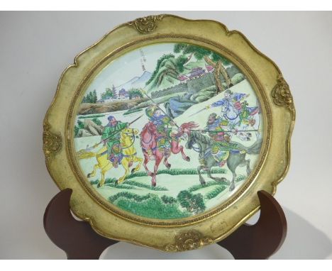 A 19th Century Chinese Canton enamel Cloisonné charger with central image of three heroes on horse back fighting against Lu B
