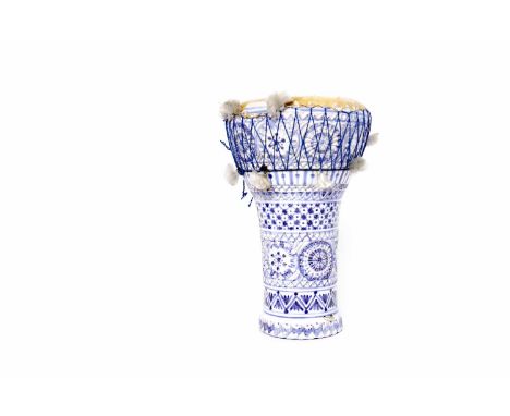 EARLY 20TH CENTURY EASTERN BLUE AND WHITE CERAMIC DRUM 
with stylised floral motifs, with leather drum covering, 34cm high 