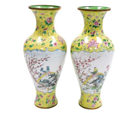 A pair of Chinese enamel famille jaune vases, of baluster form, painted with reserves of a landscape, and exotic birds and bl