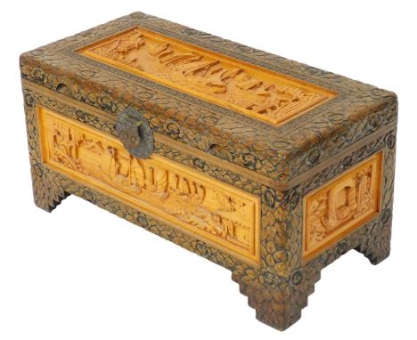 A Chinese camphor wood chest, with rose carved decoration, inset in lighter wood with carved panels depicting junks in harbou