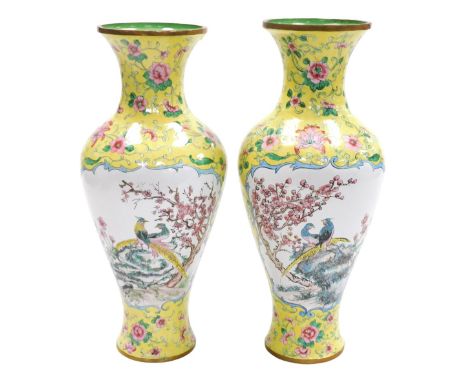 A pair of Chinese enamel famille jaune vases, of baluster form, painted with reserves of a landscape, and exotic birds and bl
