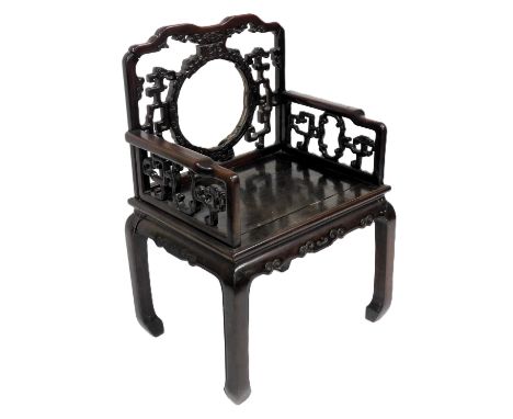 A Chinese hardwood throne chair, with a circular and scroll carved back, solid seat, raised on square legs, 73cm wide. (AF)