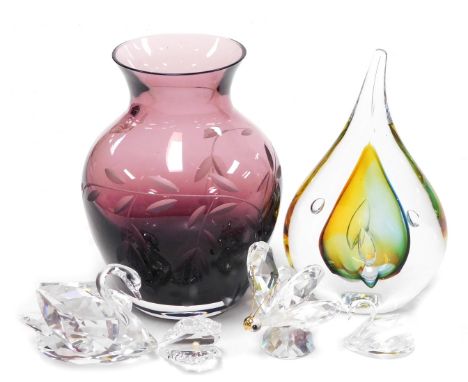 Four Swarovski crystal figures, comprising two swans, a butterfly, an oyster shell, together with a Caithness amethyst glass 