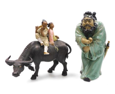 A 20thC Chinese mudman figure of Zhong Kui, modelled standing, with his right hand extended, bears seal mark, 31cm high, and 
