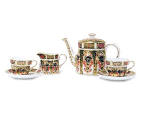 A group of Royal Crown Derby Imari porcelain miniature teawares, comprising a teapot, cream jug, and a pair of teacups and sa