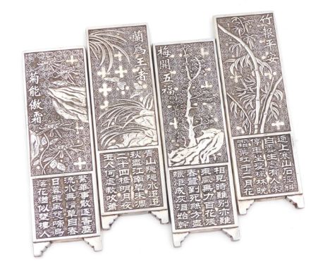 Four Chinese manuscript weights, of screen form, embossed with trees, insects and flowers, above script, white metal, 15cm hi