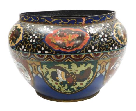 A Qing dynasty cloisonné enamel jardiniere, decorated with dragons and birds, on a blue and black ground, 36cm wide. (AF)