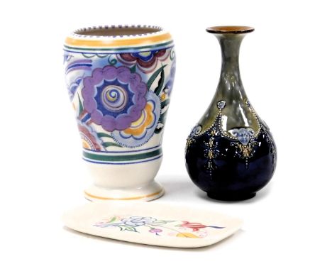 A Poole pottery vase, traditionally painted with flowers and swallows, impressed and painted marks, 18cm high, an oblong dish