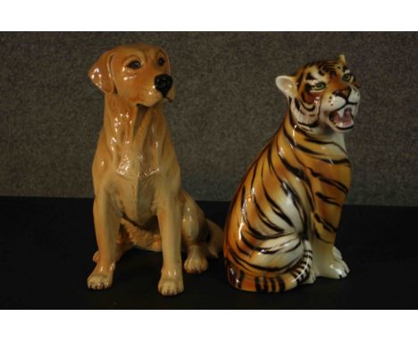 Two large hand decorated ceramic animals, a seated tiger and a golden Labrador. Impressed makers mark to the base. H.34 W.23c