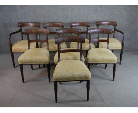 A set of eight Regency mahogany bar back dining chairs, comprising two carvers and six side chairs, the bar back set with a f