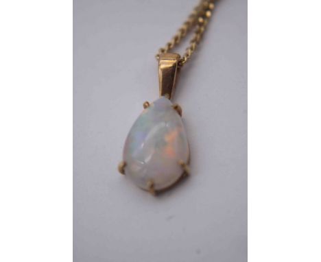 An opal drop shape pendant in five claw yellow metal setting, the opal with an approximate carat weight of 1.15 carats on a f