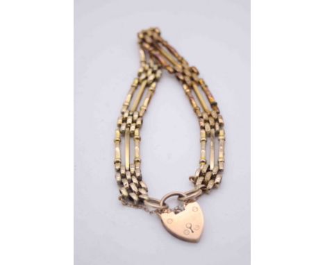 A Victorian 9 carat yellow gold gate link charm bracelet with 9ct rose heart padlock clasp with safety chain. The links with 