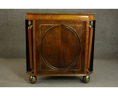 A circa 1810 Regency rosewood and satinwood corner cabinet, the rosewood top crossbanded in satinwood with a gadrooned brass 