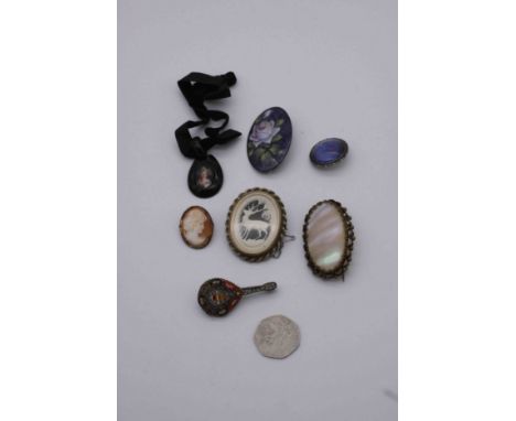 A collection of antique jewellery, including a micro mosaic brooch of a lute, a carved bone stag brooch, a hand painted porce