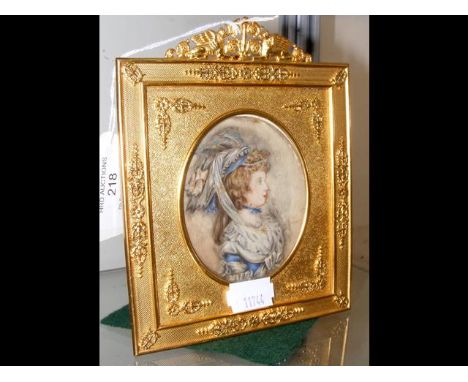 An oval miniature portrait of lady wearing bonnet in decorative ormolu frame - the frame 15cm 