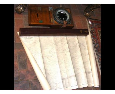 A military gimballed compass in carrying case, together with a selection of sea charts in metal tube 