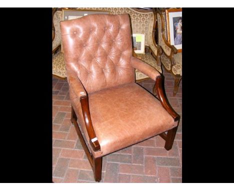 An antique button back Georgian easy chair with new brown leather upholstery  