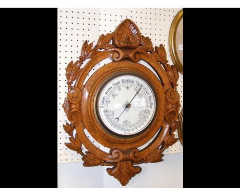 An oak framed wall barometer 