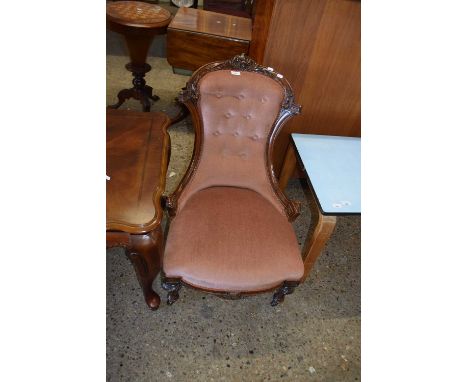 A Victorian button back nursing chair with carved walnut frame