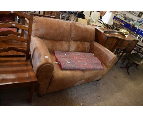 A brown leather two seater sofa