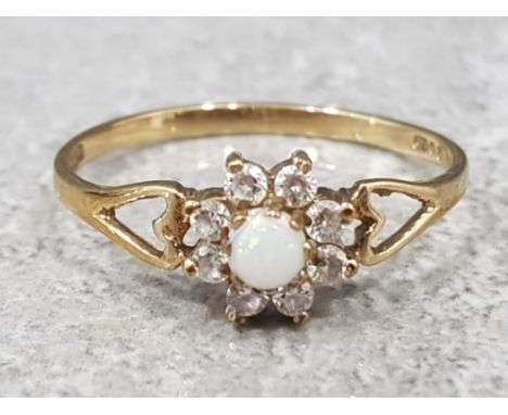 Ladies 9ct yellow gold cluster ring set with opal in the centre surrounded by eight cubic zirconias, 1g gross, size O