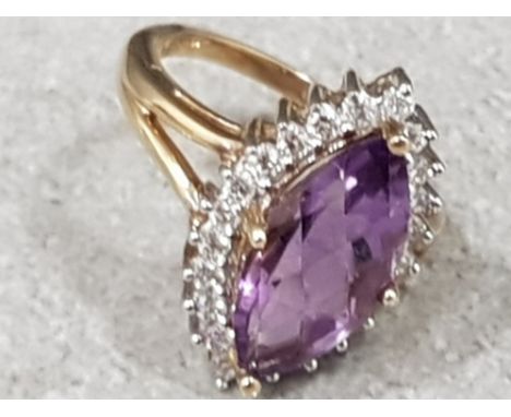 Ladies 9ct yellow gold amethyst + diamond cluste ring , featuring a marque cut amethyst In  the centre surrounded by 22 round