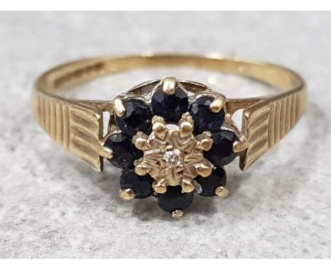 Ladies 9ct yellow gold sapphire &amp; diamond cluster ring comprising of eight black sapphires with diamond in the centre, 1.