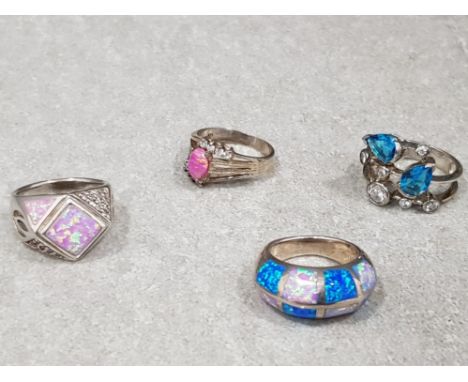 4x silver rings . 1x blue topaz + cubic zirconia cluster ring . 1x pink opal + cubic zirconia cluster ring. 1x blue + pink tu