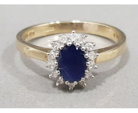 Ladies 9ct yellow gold sapphire &amp; diamond cluster ring, featuring a oval blue sapphire in the centre surrounded by 14 rou