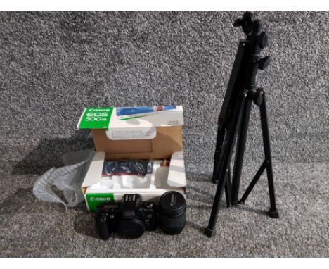 A Canon EOS 500 camera with lens and original box and accessories, together with a tripod.