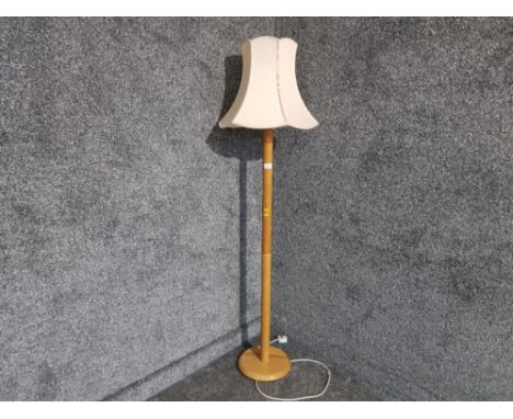 A light oak standard lamp with cream shade.