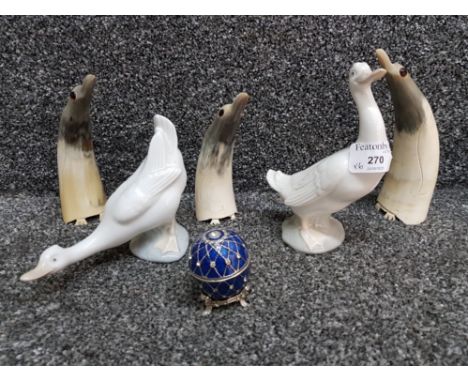 Three carved horn sculptures of penguins, two Nao Geese and a table clock in egg case.