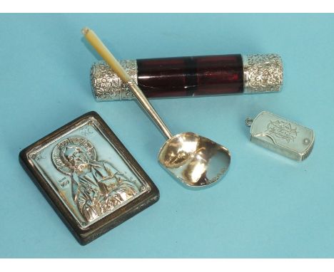 A double-edged ruby glass cylinder-shaped scent bottle with silver mounts, a miniature icon stamped '925', a tea caddy spoon 