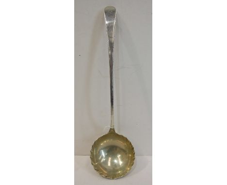 A George III ladle, the feather-edged Old English handle with shallow bowl embossed at the rim, 34cm long, London 177(5)?, __