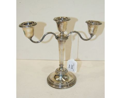 A modern table candelabrum, 21cm high, Birmingham 1960 and a short loaded candlestick, (2).