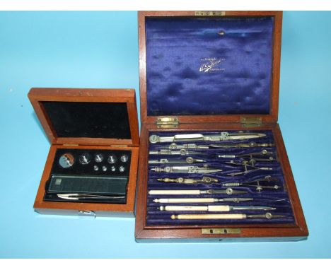 A set of drawing instruments in fitted mahogany case and an incomplete set of apothecary scales weights, (2).