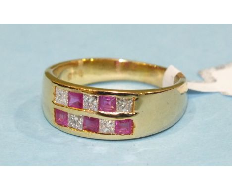 A ruby and diamond ring alternately set five each round cut rubies and square cut diamonds in two rows in 14ct gold mount, si