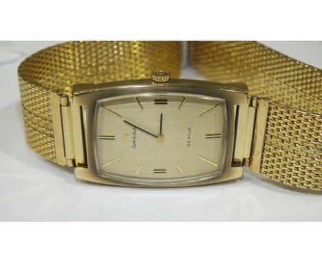 Omega de Ville, a gents wrist watch of rectangular cushion shape, the gilt face with baton numerals, the movement numbered 28