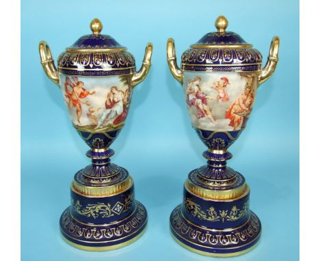 A pair of large 19th century Vienna porcelain vases and covers decorated with classical scenes and highlighted in gilt and wh