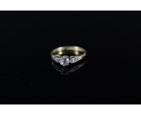 An 18ct platinum set solitaire diamond ring with small diamond set shoulders, size J 1/2, weight approx 2.3g