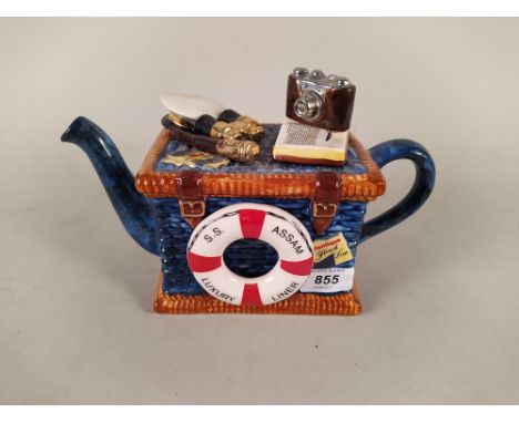 A novelty pottery teapot depicting a liner trunk 'S.S. Assam, Luxury Liner' with camera, binoculars etc on lid by 'Tony Carte