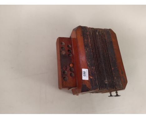 A vintage oak cased accordion
